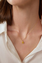 Model trägt einen tropfenförmigen Fancy Yellow Diamantanhänger aus 18K Gold mit 2,00 ct Labordiamant an einer feinen Goldkette