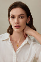 Model trägt ein filigranes Armband aus 18K Gelbgold mit gelbem Diamanten am Handgelenk.