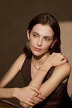 Model trägt skulpturale Triple Creolen aus massivem 18K Gold in einer eleganten Editorial Aufnahme.