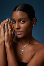 Model trägt drei Solitär-Diamantketten aus 18K Weißgold mit runden Labordiamanten in unterschiedlichen Größen sowie passenden Diamantschmuck.